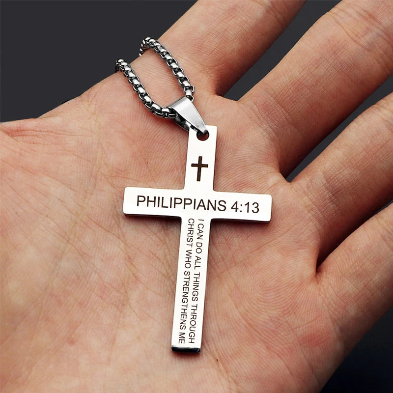 Close-up of the engraved scripture text on the cross, showing the clarity of the verse, font detail, depth of engraving, and metal texture.
