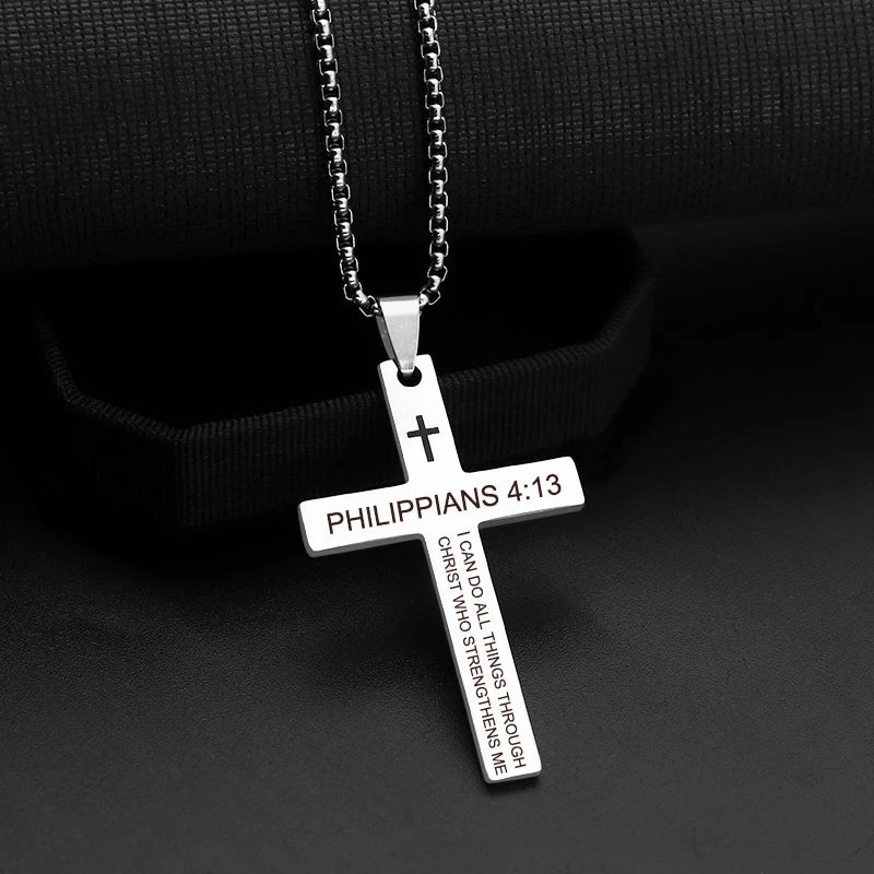 Cross pendant on its chain worn around the neck of a model, illustrating how it sits against the chest and the chain length in real use.