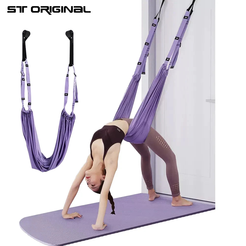 User performing leg and back stretches using aerial yoga straps in home studio environment — demonstrating splits, inversion, flexibility, and safe strap usage.