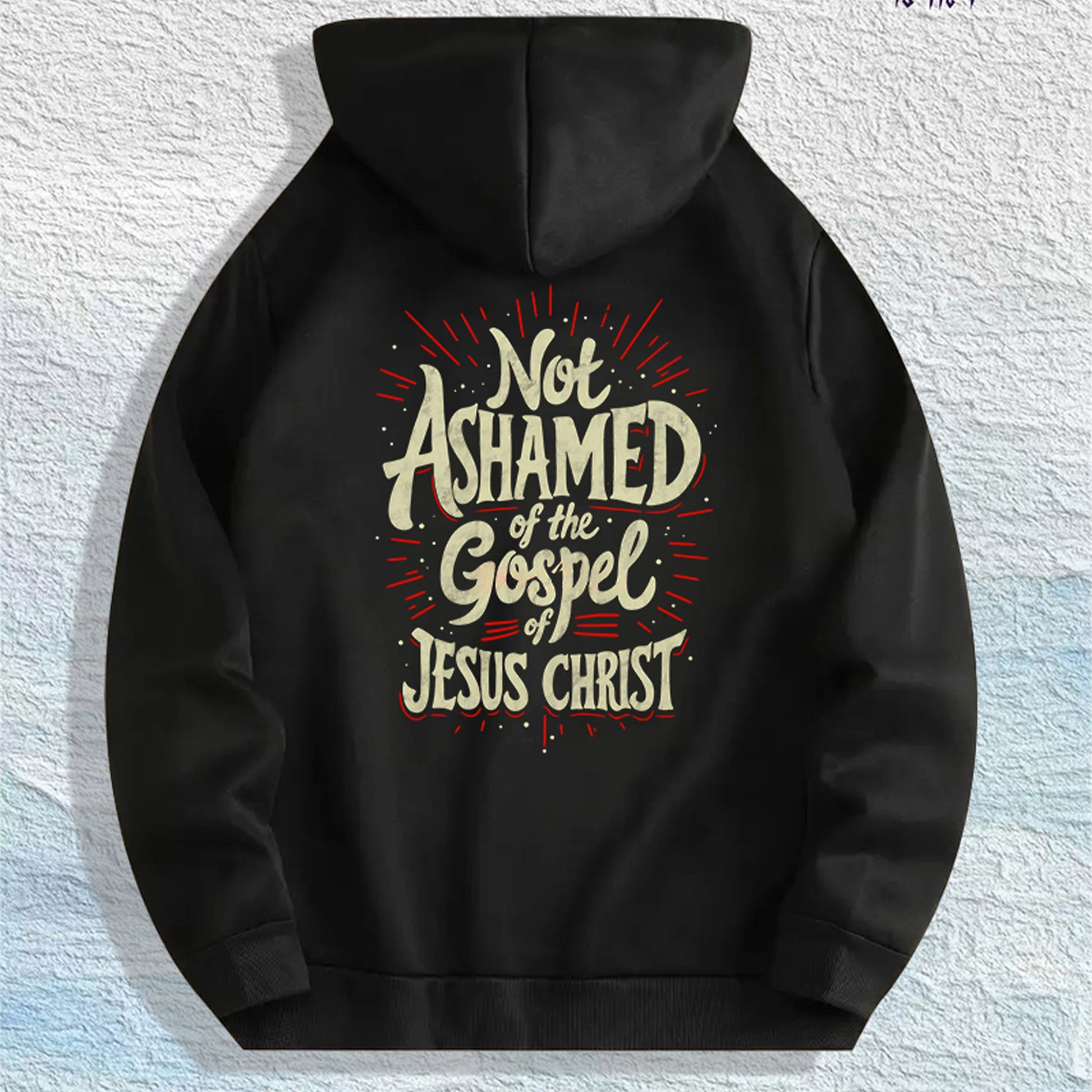 Front view of the ‘Not Ashamed of the Gospel’ Christian hoodie in one of its color options, showing the scripture-inspired bold text across the chest.
