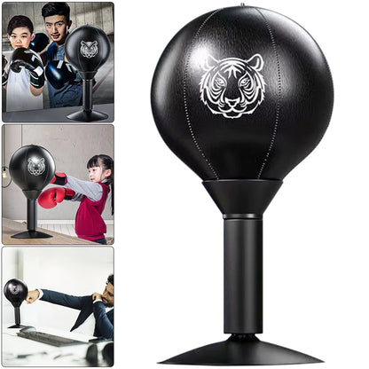 “User throwing punches at the desktop punch ball mounted on a table via suction cup — demonstrating its use for reflex training, stress relief, and rapid strikes.